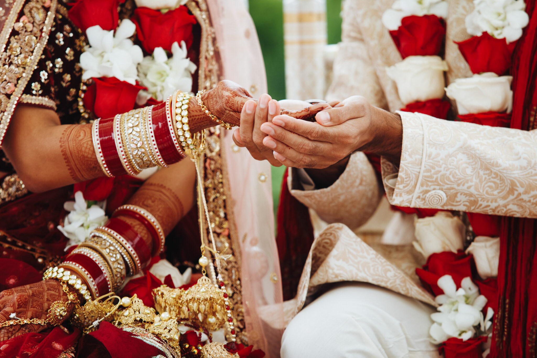 Hands of indian bride and groom intertwined together making auth